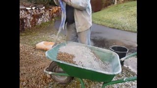 Mixing concrete by hand in a wheelbarrow the easy way [upl. by Helbonnas]