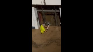 Man smashes glass door to save children in Spanish floods [upl. by Sidman]