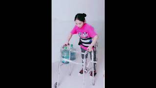 Paraplegic girl relearning how to walk with braces and walker [upl. by Ailahk219]