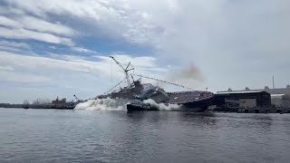 USS Cleveland LCS douses tugboat during lastever side launch at Wisconsin shipyard [upl. by Lati]